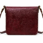 Model wearing Handmade Floral Embossed Leather Crossbody Bag - Burgundy - ASL Egypt